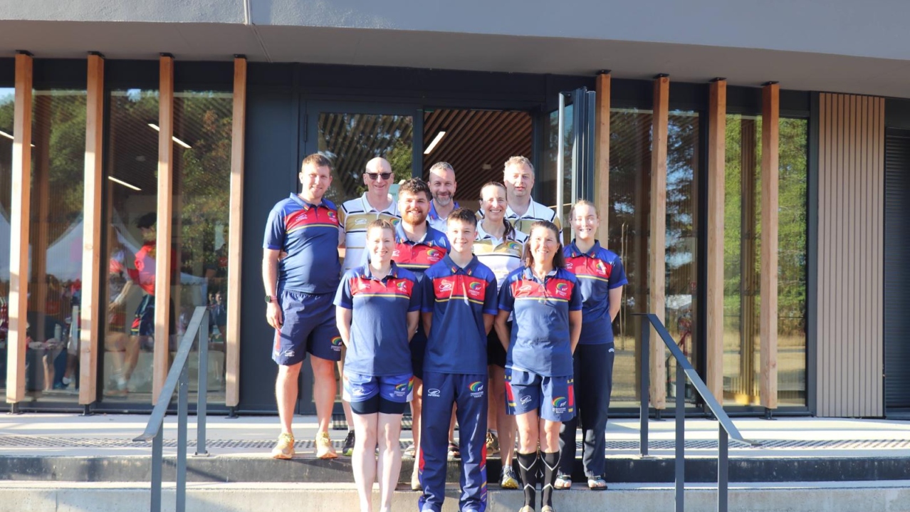 The Scottish referee team in team kit posing on the steps of a building at the European Touch Championships in Vichy