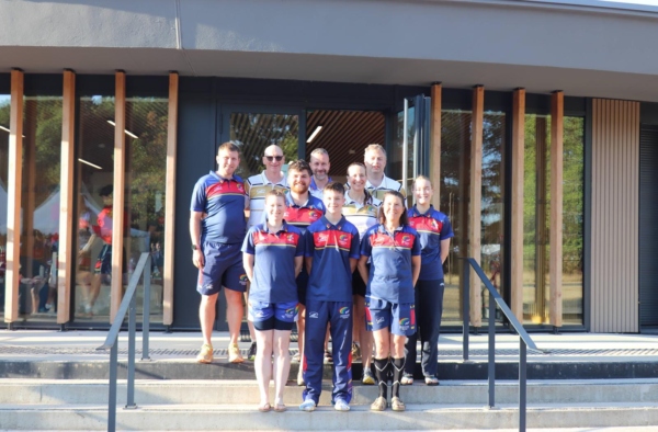 The Scottish referee team in team kit posing on the steps of a building at the European Touch Championships in Vichy