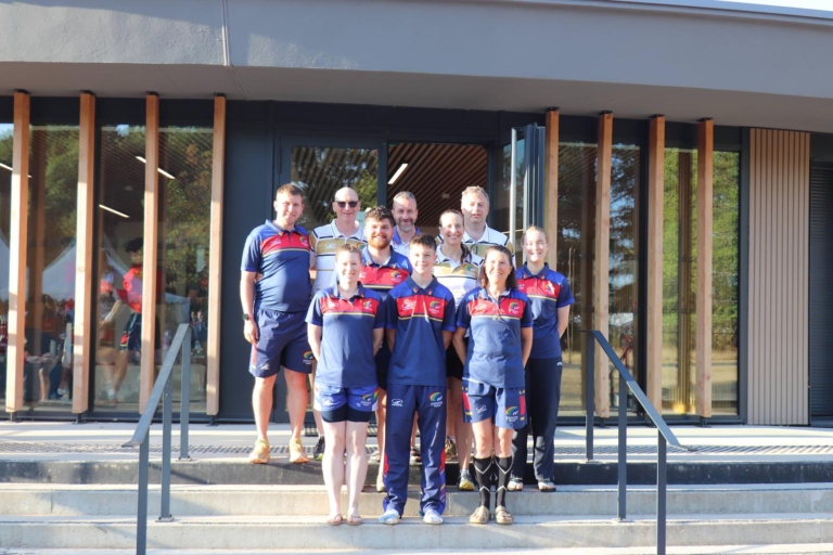 The Scottish referee team in team kit posing on the steps of a building at the European Touch Championships in Vichy